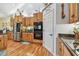 Kitchen featuring wooden cabinets, stainless steel appliances, granite countertops, and tile backsplash at 7264 Spencer Parrish Rd, Parrish, FL 34219