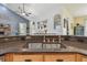 Kitchen island with wood cabinets and granite countertops open to the living room with vaulted ceilings at 7264 Spencer Parrish Rd, Parrish, FL 34219