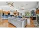 Open-concept living room with a hardwood floor, a stone fireplace, and views of the backyard at 7264 Spencer Parrish Rd, Parrish, FL 34219