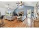 Living room featuring vaulted ceilings, fireplace, hardwood floors, and abundant natural light at 7264 Spencer Parrish Rd, Parrish, FL 34219