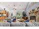 Spacious living room with hardwood floors, stone fireplace, and ample natural light at 7264 Spencer Parrish Rd, Parrish, FL 34219