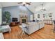 Spacious living room with vaulted ceilings, hardwood floors, a stone fireplace, and comfortable seating arrangement at 7264 Spencer Parrish Rd, Parrish, FL 34219