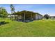 Covered patio with seating and outdoor kitchen is perfect for entertaining and relaxing at 7264 Spencer Parrish Rd, Parrish, FL 34219