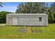 Exterior of shed showing door, window and small gardens at 7264 Spencer Parrish Rd, Parrish, FL 34219