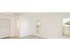 Bright bedroom with gray wood-look floors, white walls, closet and large windows offering lots of natural light at 7308 17Th W Ave, Bradenton, FL 34209