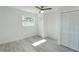 Bright bedroom with a ceiling fan, window, wood-look floors, and closet with louvered doors at 7308 17Th W Ave, Bradenton, FL 34209