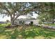Charming single-story home with a well-manicured lawn and mature trees offering plenty of shade at 7308 17Th W Ave, Bradenton, FL 34209