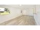 Light-filled living room boasts stylish gray wood-look floors, white walls, and a view to the front yard at 7308 17Th W Ave, Bradenton, FL 34209