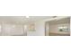 Open living area showcases stylish gray wood-look floors, white walls, and easy access to adjacent rooms at 7308 17Th W Ave, Bradenton, FL 34209