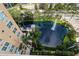 Scenic aerial view of community pond with fountain and mature tropical landscaping at 750 N Tamiami Trl # 1005, Sarasota, FL 34236