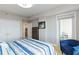 Cozy bedroom with private balcony, ample closet space, and stylish decor at 750 N Tamiami Trl # 1005, Sarasota, FL 34236