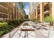 Peaceful courtyard with fountain, benches, lush landscaping and covered walkway at 750 N Tamiami Trl # 1005, Sarasota, FL 34236