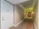 Hallway with neutral-toned striped wallpaper and ornate patterned carpet at 750 N Tamiami Trl # 1005, Sarasota, FL 34236