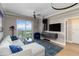 Bright living room has a modern sectional, water view and balcony access at 750 N Tamiami Trl # 1005, Sarasota, FL 34236