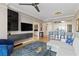 Stylish living area with modern entertainment setup and open view to kitchen at 750 N Tamiami Trl # 1005, Sarasota, FL 34236