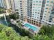 Aerial shot of the condo pool, fountain, surrounding green space, and outdoor seating at 750 N Tamiami Trl # 1005, Sarasota, FL 34236