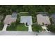 Birds-eye view of a well-kept home featuring a large yard, landscaping, and a two-car garage at 813 Oak Pond Dr, Osprey, FL 34229