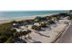 Breathtaking aerial view of a pristine beach featuring shady picnic structures, palm trees, and white sands at 813 Oak Pond Dr, Osprey, FL 34229