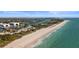 Expansive aerial view showing the beach, calm waters, and nearby waterways connected to the ocean at 813 Oak Pond Dr, Osprey, FL 34229