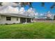 This backyard features a well-maintained lawn and a screened-in lanai attached to the home at 813 Oak Pond Dr, Osprey, FL 34229
