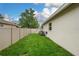 Side yard with green grass and a fence for added privacy at 813 Oak Pond Dr, Osprey, FL 34229