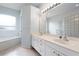 Bright bathroom featuring a double vanity, soaking tub, and a glass block shower at 813 Oak Pond Dr, Osprey, FL 34229