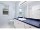 The bathroom has white cabinets and tile floors, with a dark blue countertop at 813 Oak Pond Dr, Osprey, FL 34229