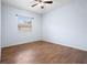 Empty bedroom with a ceiling fan, hard wood floors, and a window providing natural light at 813 Oak Pond Dr, Osprey, FL 34229