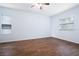 Spacious bedroom with hardwood floors, two windows, and a ceiling fan at 813 Oak Pond Dr, Osprey, FL 34229