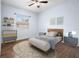 Stylishly decorated bedroom featuring a ceiling fan and a window with modern furnishings at 813 Oak Pond Dr, Osprey, FL 34229