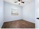 This is a light blue bedroom that features brown wood floors and a ceiling fan at 813 Oak Pond Dr, Osprey, FL 34229
