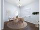Cozy dining room features modern lighting fixture and wood floors at 813 Oak Pond Dr, Osprey, FL 34229