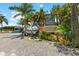 Charming entrance to the beach house with rentals of paddleboards, boats, waverunners, and kayaks at 813 Oak Pond Dr, Osprey, FL 34229