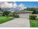 Well-maintained single-story home boasting an attached two-car garage and mature landscaping at 813 Oak Pond Dr, Osprey, FL 34229