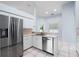 Spacious kitchen with stainless steel appliances, light countertops, and a pass through at 813 Oak Pond Dr, Osprey, FL 34229