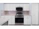 This modern kitchen features stainless steel appliances, clean white cabinets, and light countertops at 813 Oak Pond Dr, Osprey, FL 34229