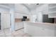 The kitchen boasts white cabinets and light countertops, plus stainless steel appliances at 813 Oak Pond Dr, Osprey, FL 34229