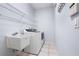 A laundry room featuring a sink, shelving, and a newer model washing machine at 813 Oak Pond Dr, Osprey, FL 34229