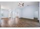 Spacious living room with wood floors, ceiling fan, and neutral paint at 813 Oak Pond Dr, Osprey, FL 34229
