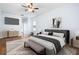 Comfortable main bedroom featuring ceiling fan, wood floors, and decor at 813 Oak Pond Dr, Osprey, FL 34229