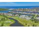 Stunning aerial view showcases Apollo Beach homes along winding canals, a lake, and a golf course near Tampa Bay at 815 Greenview Dr, Apollo Beach, FL 33572