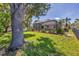 Large lawn and trees frame an enclosed backyard pool and patio at 815 Greenview Dr, Apollo Beach, FL 33572