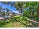 Large backyard featuring lush grass, mature trees, and an enclosed pool at 815 Greenview Dr, Apollo Beach, FL 33572