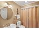Bathroom with round mirror, vanity sink, and curtained shower at 815 Greenview Dr, Apollo Beach, FL 33572