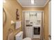 Bathroom featuring vanity, toilet, and closet housing washer and dryer at 815 Greenview Dr, Apollo Beach, FL 33572