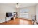 Empty bedroom featuring a large window, ceiling fan, and hardwood floors at 815 Greenview Dr, Apollo Beach, FL 33572
