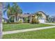 Charming single-Gathering home with beautiful landscaping, lush lawn and mature palm trees at 815 Greenview Dr, Apollo Beach, FL 33572