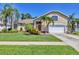 Charming single-Gathering home with lush landscaping, mature palm trees and two car garage at 815 Greenview Dr, Apollo Beach, FL 33572