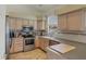 Kitchen with stainless steel appliances and light wooden cabinets with countertop at 815 Greenview Dr, Apollo Beach, FL 33572
