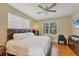 Spacious main bedroom with wood floors, large windows, and a comfortable king-size bed, creating a relaxing retreat at 815 Greenview Dr, Apollo Beach, FL 33572
